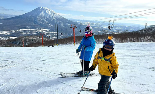 Family skiing in Niseko Japan with kids in powder snow